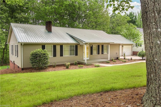 ranch-style home featuring a front yard, a garage, and covered porch