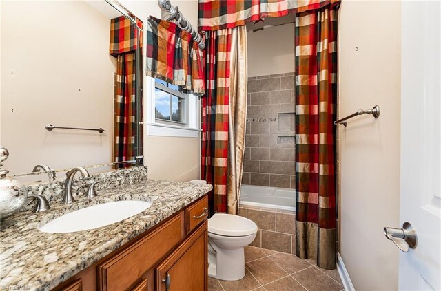 full bath featuring tile patterned flooring, tiled shower / bath, toilet, and vanity