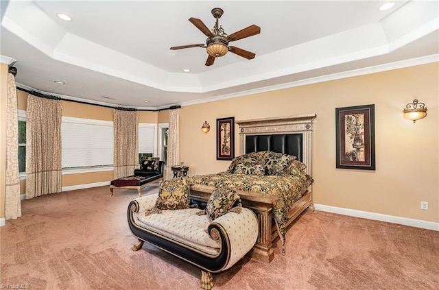 bedroom with a tray ceiling, carpet flooring, baseboards, recessed lighting, and crown molding