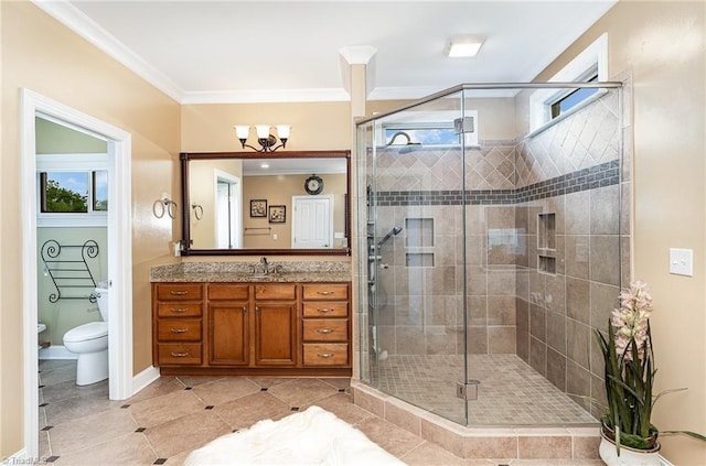 full bath featuring a stall shower, plenty of natural light, vanity, toilet, and crown molding