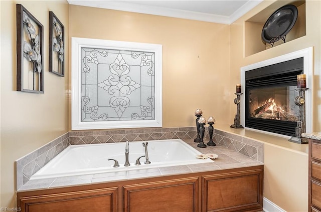 bathroom with a bath and a glass covered fireplace