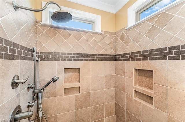 bathroom view of tiled shower and crown molding