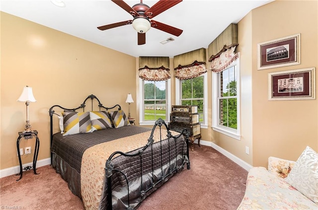 carpeted bedroom with baseboards and a ceiling fan