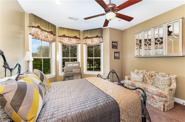 carpeted bedroom featuring ceiling fan and baseboards