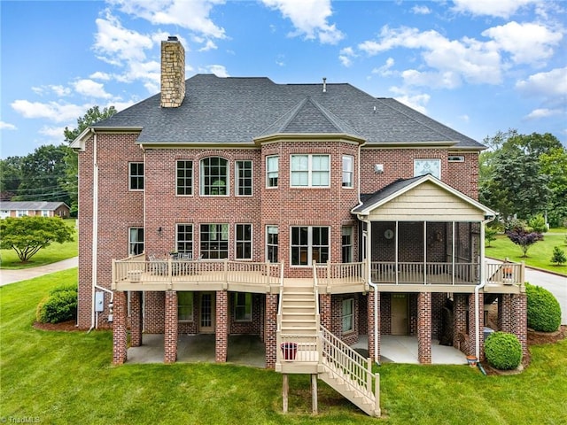 back of property featuring a patio, a sunroom, and a lawn