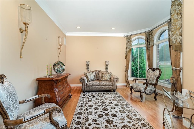 living area featuring crown molding, wood finished floors, baseboards, and recessed lighting