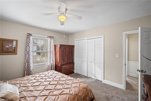 bedroom with a closet, carpet flooring, ceiling fan, and baseboards