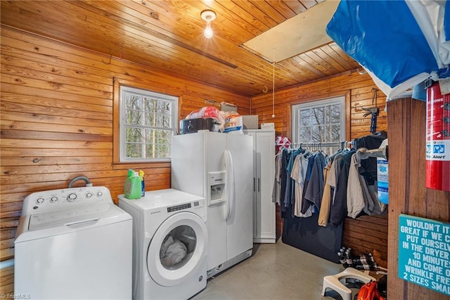 laundry area featuring laundry area, wooden ceiling, washing machine and dryer, and wooden walls