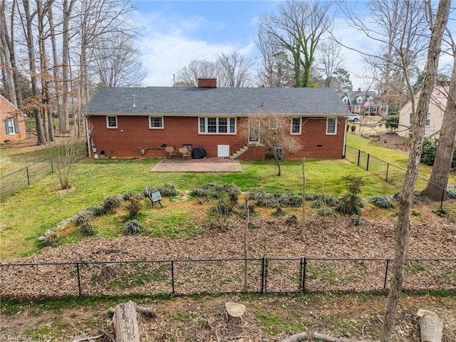 back of property featuring a fenced backyard, a chimney, crawl space, a yard, and brick siding