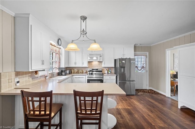 kitchen with plenty of natural light, stainless steel appliances, a sink, and light countertops