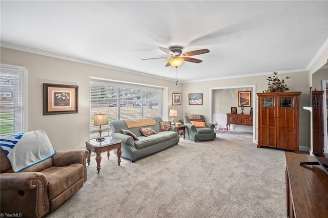 carpeted living area with crown molding and ceiling fan