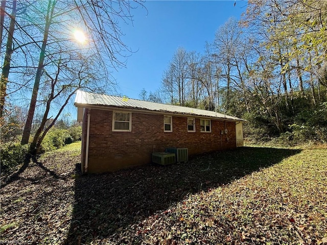 view of side of home featuring central AC unit