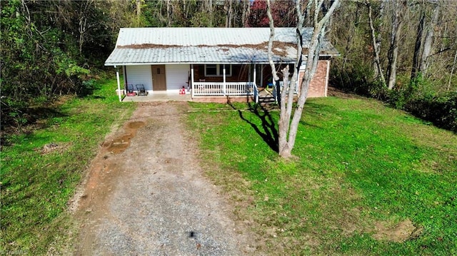 view of front of home with covered porch and a front yard