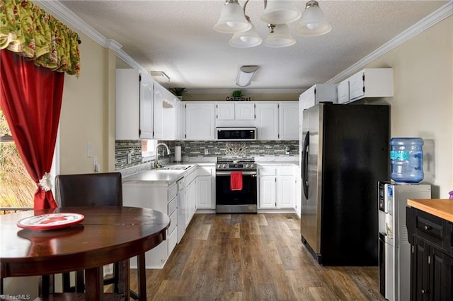 kitchen featuring stainless steel appliances, dark hardwood / wood-style floors, white cabinetry, and ornamental molding