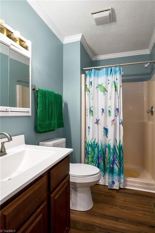 bathroom with wood-type flooring, ornamental molding, walk in shower, vanity, and a textured ceiling