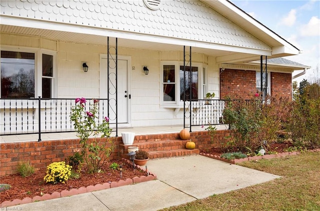 view of exterior entry with a porch