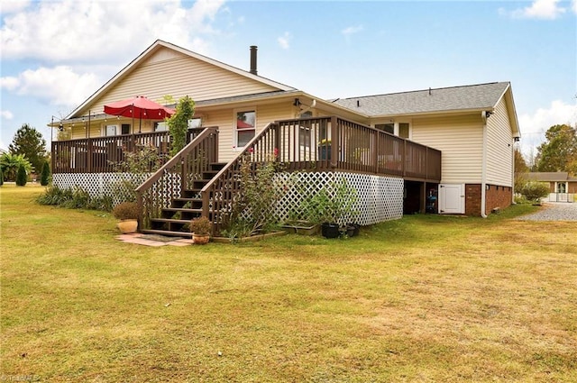 back of property with a wooden deck and a lawn