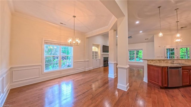 5567 Foxgate Cir, Winston-Salem, NC 27106 - kitchen with dishwasher, brown cabinetry, light stone countertops, dark wood-style flooring, and crown molding