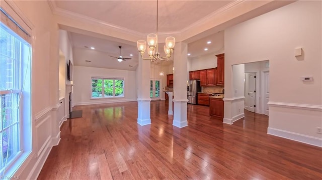 5567 Foxgate Cir, Winston-Salem, NC 27106 - unfurnished living room with a chandelier, dark wood-style flooring, ornamental molding, a high ceiling, and decorative columns
