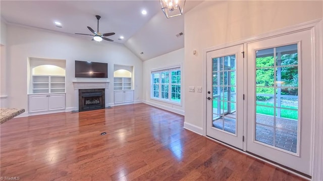 5567 Foxgate Cir, Winston-Salem, NC 27106 - unfurnished living room with built in features, a ceiling fan, vaulted ceiling, a fireplace, and wood finished floors