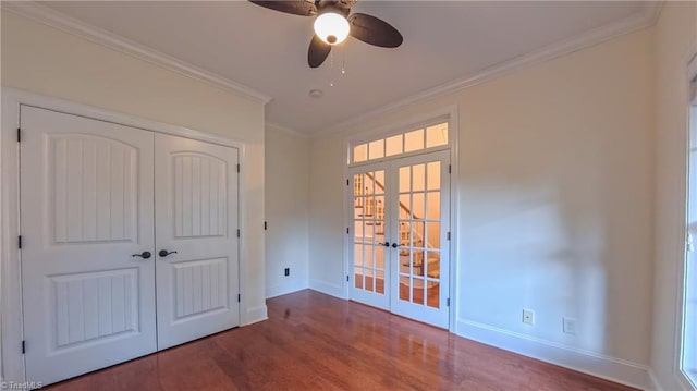 5567 Foxgate Cir, Winston-Salem, NC 27106 - unfurnished bedroom featuring french doors, wood finished floors, crown molding, a closet, and a ceiling fan