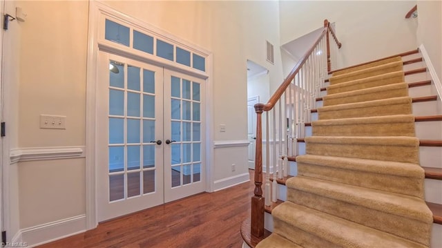 5567 Foxgate Cir, Winston-Salem, NC 27106 - stairs featuring french doors, wood finished floors, and a high ceiling