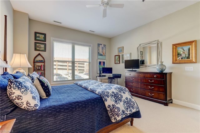 carpeted bedroom with a ceiling fan, baseboards, and visible vents