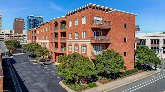 view of building exterior with uncovered parking