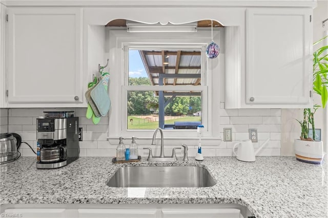 2664 Old Thomasville Rd, Winston-Salem, NC 27107 - kitchen featuring white cabinetry, tasteful backsplash, and light stone counters