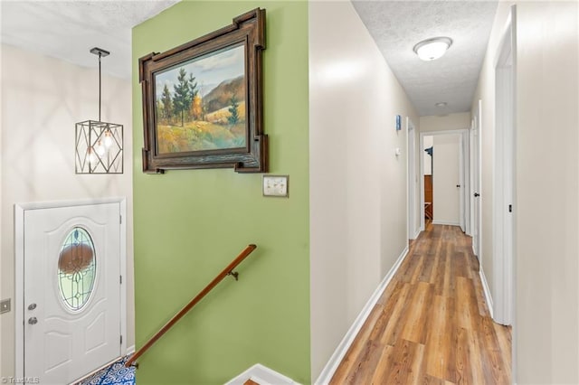 2664 Old Thomasville Rd, Winston-Salem, NC 27107 - corridor with a textured ceiling, light wood-type flooring, and an upstairs landing