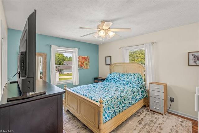 2664 Old Thomasville Rd, Winston-Salem, NC 27107 - bedroom with light wood-type flooring, a ceiling fan, and a textured ceiling