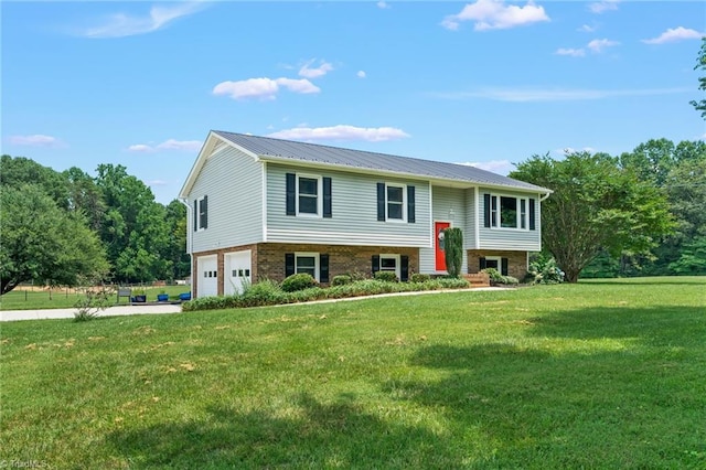 2664 Old Thomasville Rd, Winston-Salem, NC 27107 - raised ranch featuring a garage, a front lawn, concrete driveway, a metal roof, and brick siding