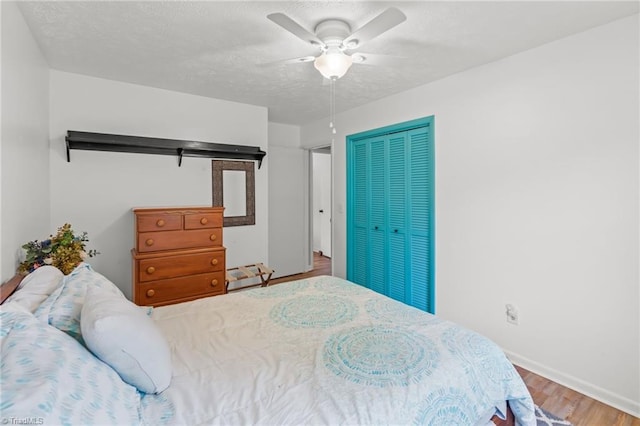 2664 Old Thomasville Rd, Winston-Salem, NC 27107 - bedroom with wood finished floors, a closet, a ceiling fan, and a textured ceiling