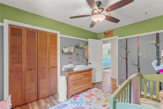 2664 Old Thomasville Rd, Winston-Salem, NC 27107 - bedroom with a closet, wood finished floors, a ceiling fan, and a crib