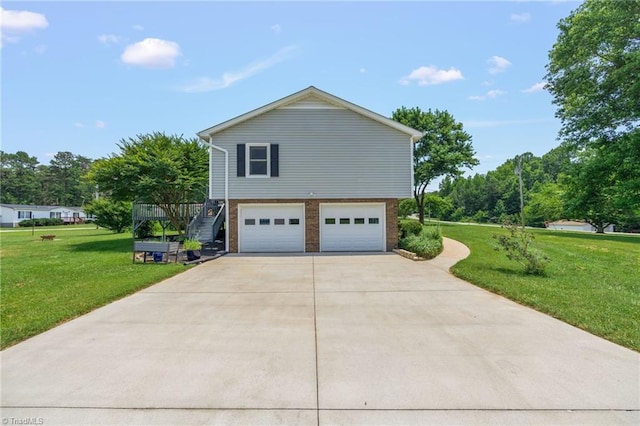 2664 Old Thomasville Rd, Winston-Salem, NC 27107 - view of side of property with stairway, a garage, concrete driveway, and a lawn