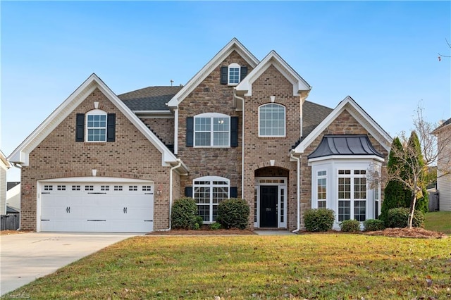 view of front of home featuring a garage and a front lawn