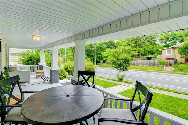 view of patio with outdoor dining area and covered porch