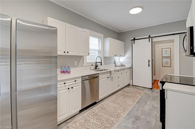 kitchen with appliances with stainless steel finishes, a sink, white cabinets, crown molding, and light countertops
