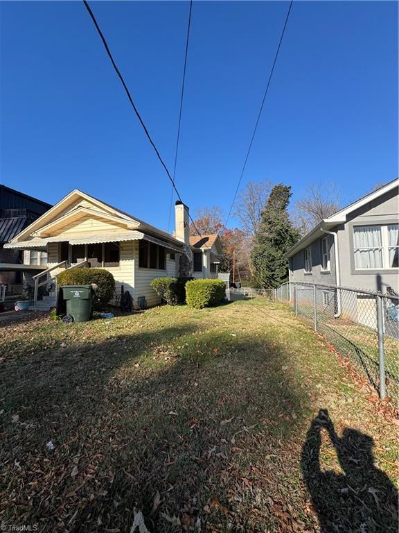 view of side of home featuring a yard