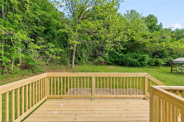 wooden deck featuring a lawn