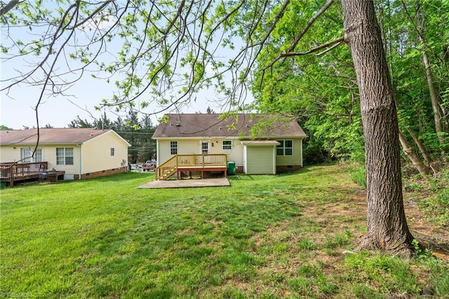 back of property with a yard, crawl space, and a wooden deck