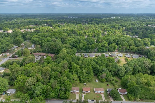 birds eye view of property featuring a wooded view