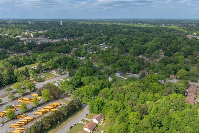 drone / aerial view featuring a wooded view