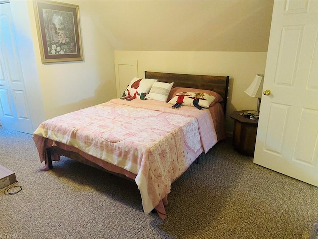 carpeted bedroom with vaulted ceiling
