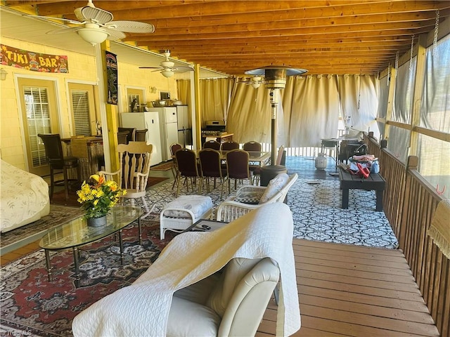 living room featuring hardwood / wood-style flooring and ceiling fan