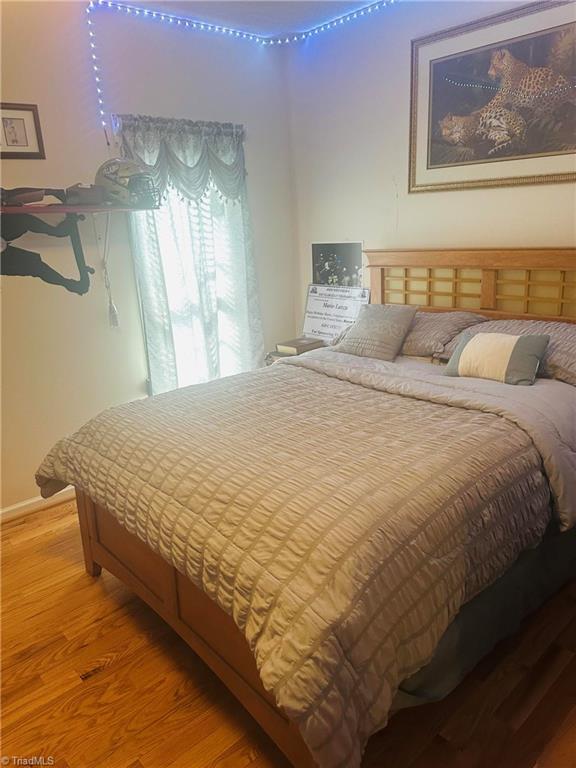 bedroom featuring wood finished floors