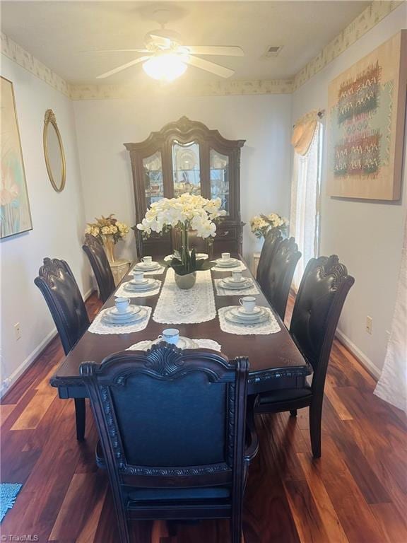 dining space featuring visible vents, ceiling fan, wood finished floors, and baseboards