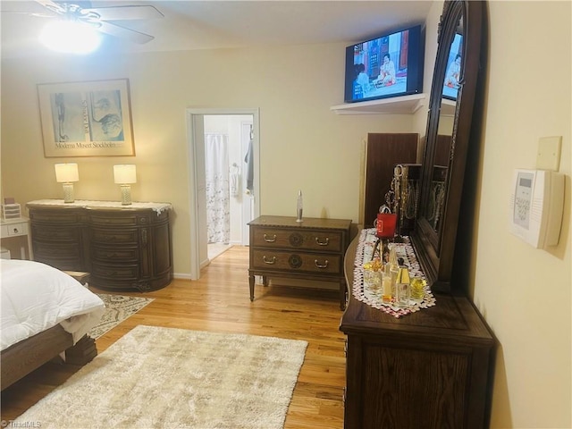bedroom featuring light wood-style flooring and ensuite bathroom