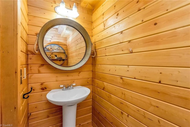 bathroom featuring wooden walls