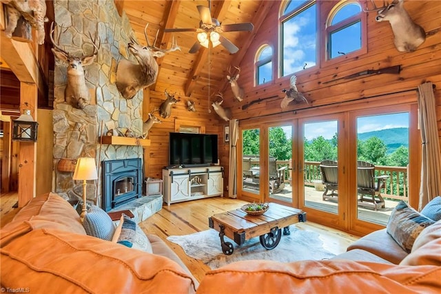 living area with wood walls, wooden ceiling, wood finished floors, and a wealth of natural light